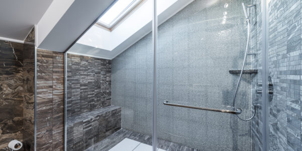 Glass shower cabin in modern loft bathroom